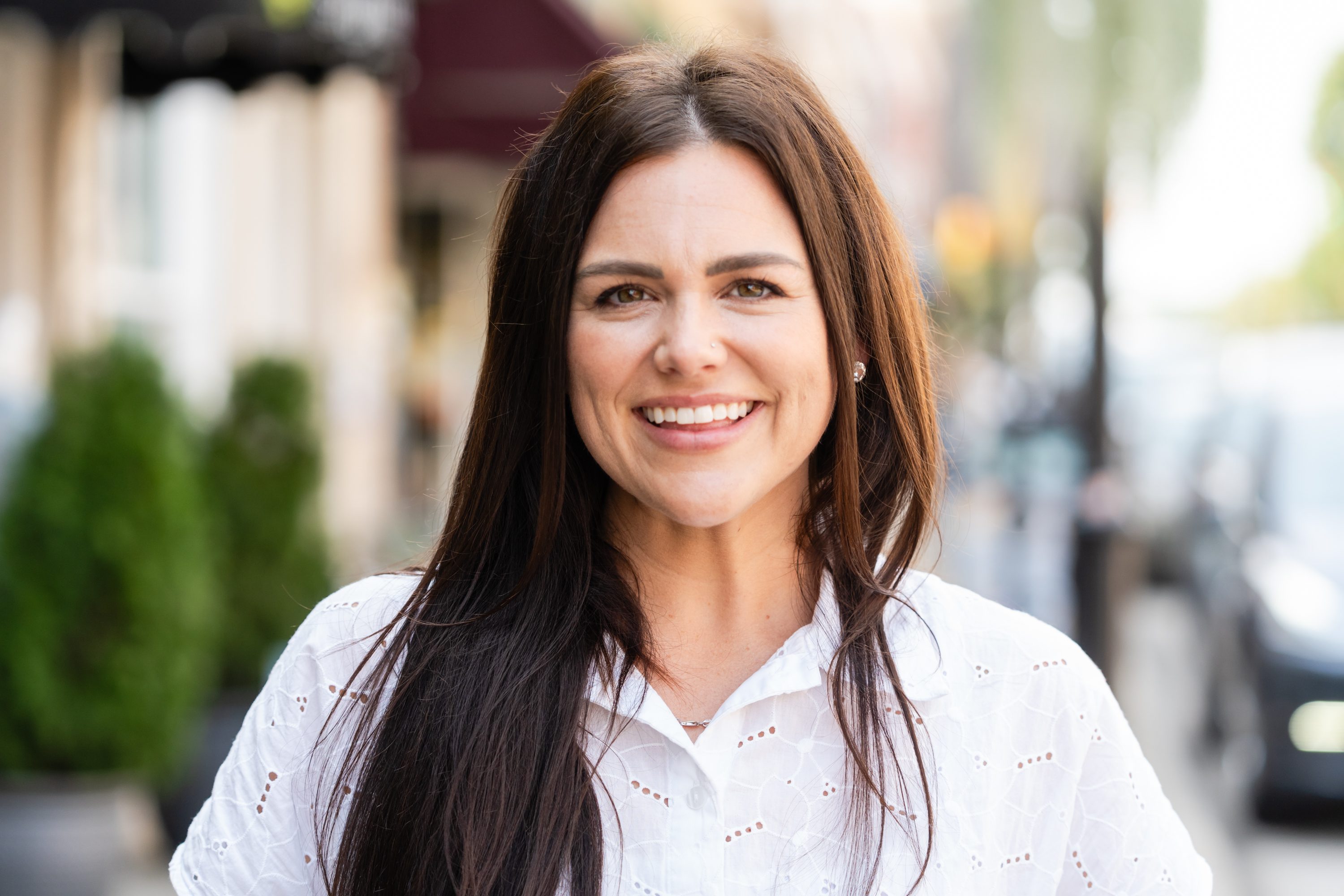 A woman with long hair smiling for the camera.