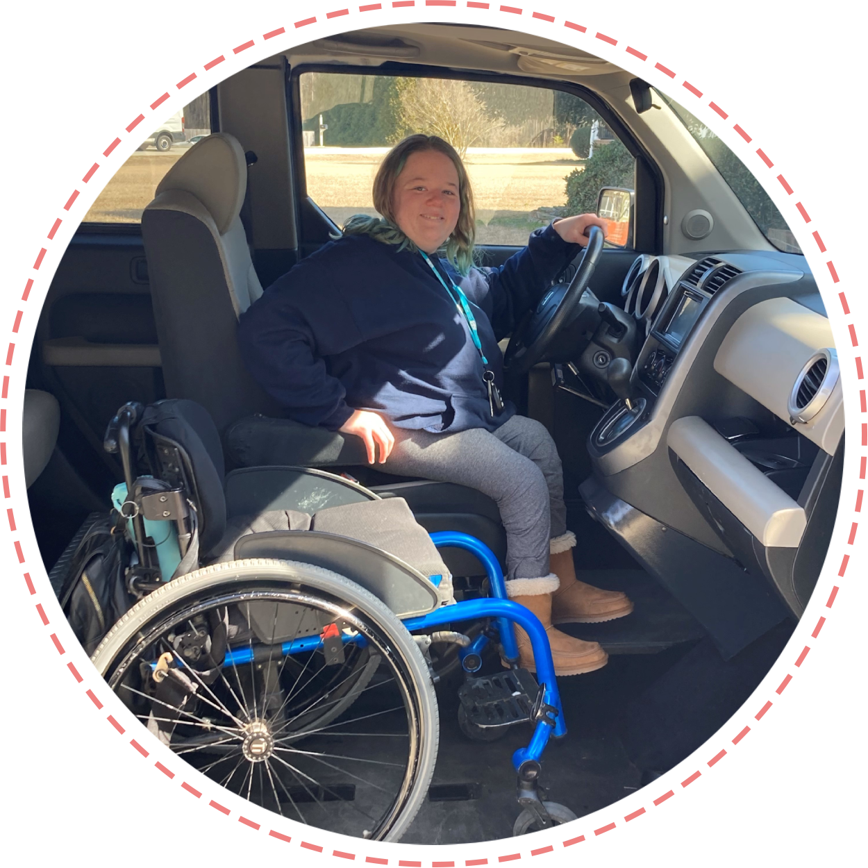 A woman in a wheelchair sitting in the driver 's seat of a truck.