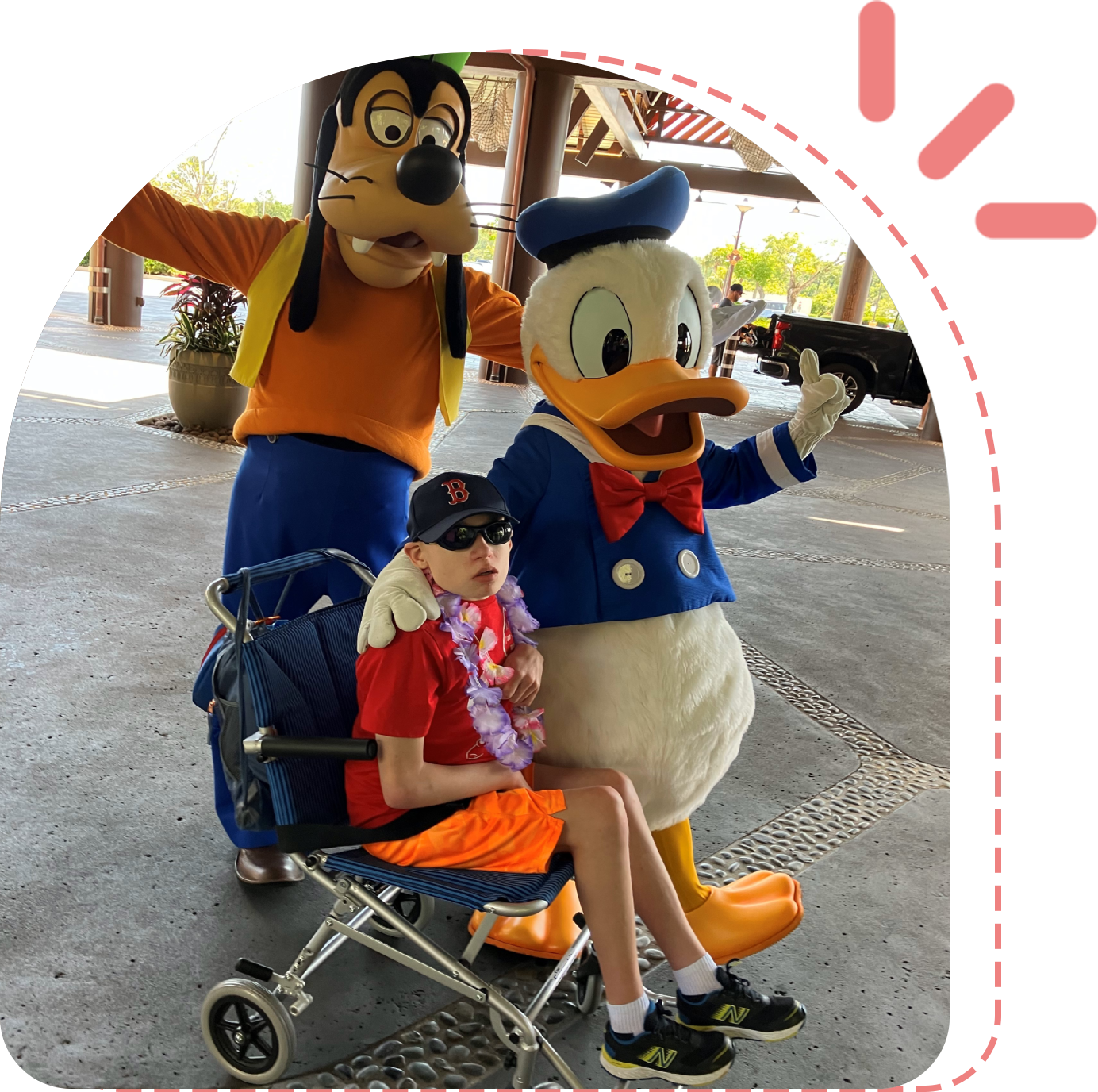 A woman sitting in a stroller with two goofy characters.